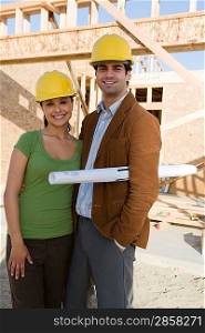 Young couple in construction site