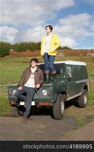 Young couple in countryside with SUV