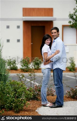 Young couple in front of apartments