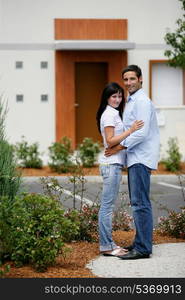 Young couple in front of apartments