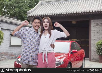 Young Couple in Front of Their Car