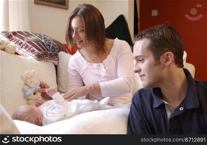 young couple in house with new baby