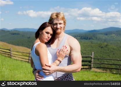 Young couple in love at countryside summer landscape