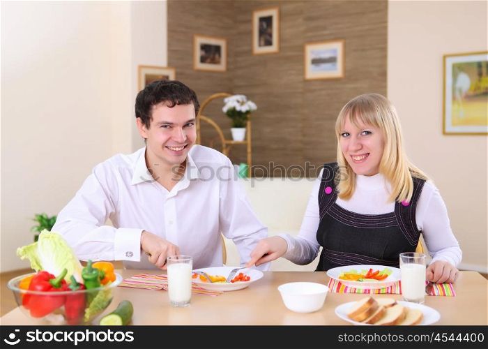young couple in love at home eating together and having fun