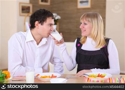 young couple in love at home eating together and having fun