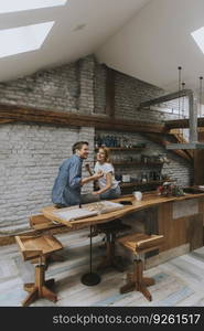 Young couple in love eating pizza for sneck in the rustic home