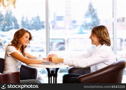 Young couple in love having a date in restaurant