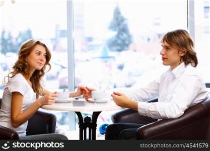 Young couple in love having a date in restaurant