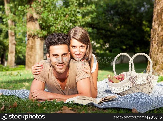 Young couple in love having a picnik outdoor in a park