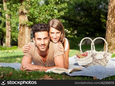 Young couple in love having a picnik outdoor in a park