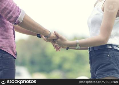 Young couple in love holding hands together with sweet time moment romance love. Romantic relation two people boy friend and girl friend holding hands with happiness. Sweet happy valentine concept.