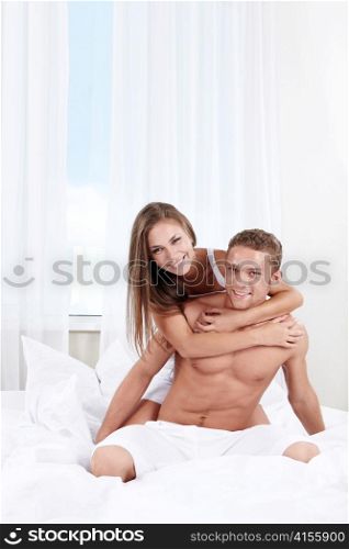 Young couple in love in the bedroom