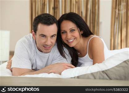 Young couple in love laying in bed