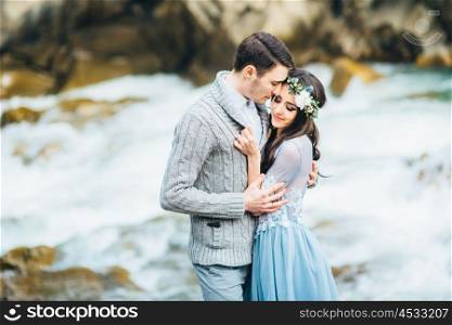 young couple in love on a mountain river