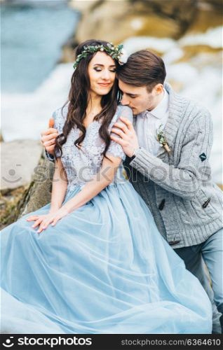 young couple in love on a mountain river in the Carpathian mountains
