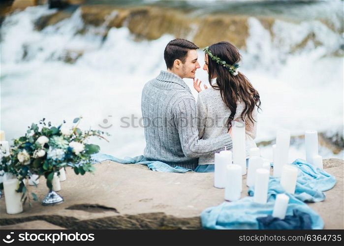 young couple in love on a mountain river in the Carpathian mountains