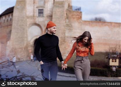 Young couple in love outdoor.Stunning sensual outdoor portrait of young stylish fashion couple posing in summer in field. couple walking in the city. selective focus