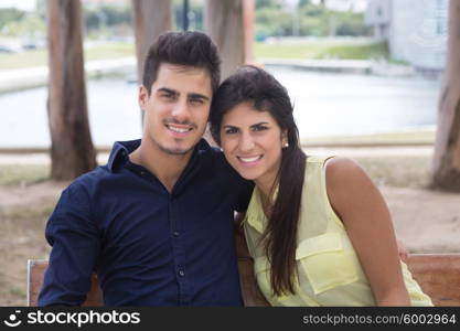 young couple in love, relaxing at the city park