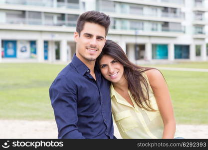 young couple in love, relaxing at the city park