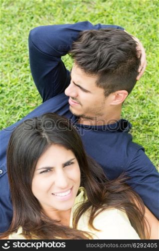 young couple in love, relaxing at the city park