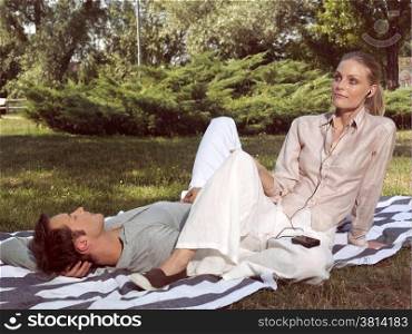 young couple in love resting in the park