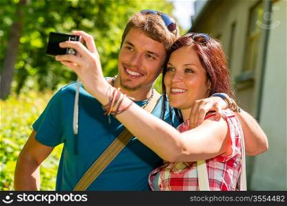 Young couple in love take picture of themselves outdoor