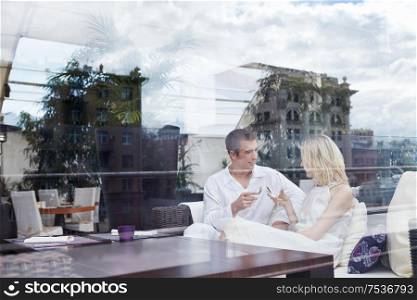 Young couple in love through the glass at a restaurant