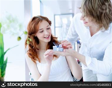 young couple in love together presenting a gift