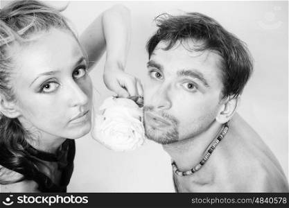 Young couple in love with a white rose and silver make-up closeup