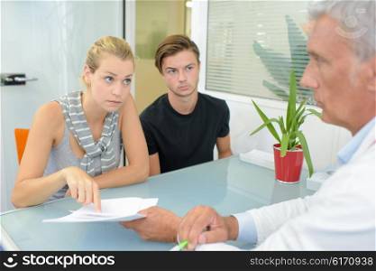 Young couple in meeting with doctor