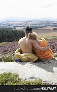Young Couple In Sleeping Bags Admiring View