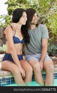 Young couple in swimming pool on vacation