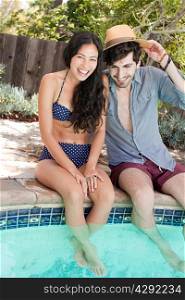 Young couple in swimming pool on vacation
