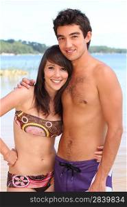 Young couple in swimwear on a beach