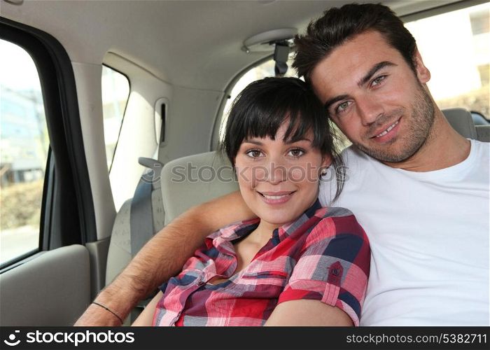 Young couple in the back of a car