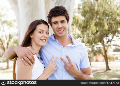 Young couple in the park celebrating. Young happy couple in the park in the summer