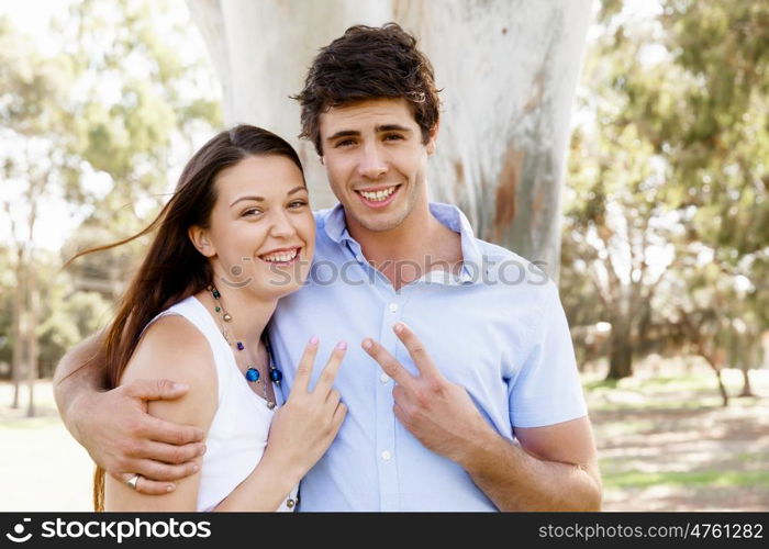 Young couple in the park celebrating. Young happy couple in the park in the summer