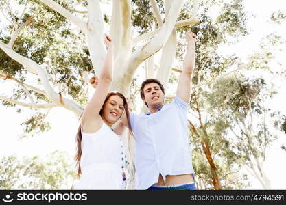 Young couple in the park celebrating. Young happy couple in the park in the summer