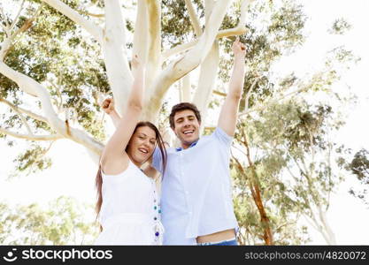 Young couple in the park celebrating. Young happy couple in the park in the summer