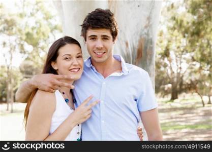 Young couple in the park celebrating. Young happy couple in the park in the summer