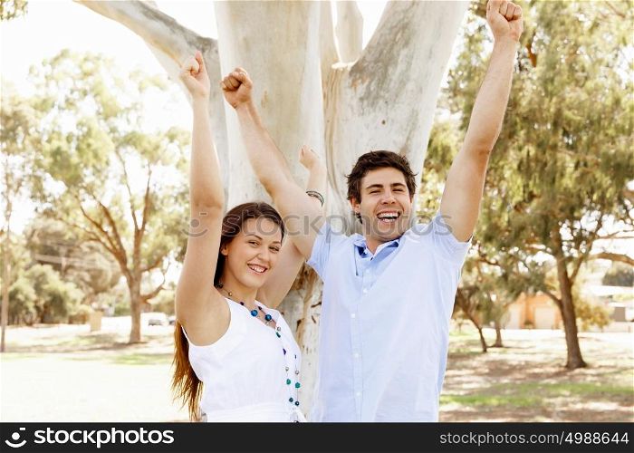 Young couple in the park celebrating. Young happy couple in the park in the summer