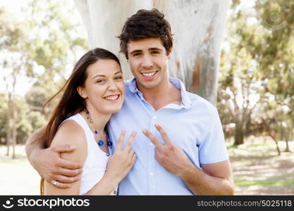 Young couple in the park celebrating. Young happy couple in the park in the summer