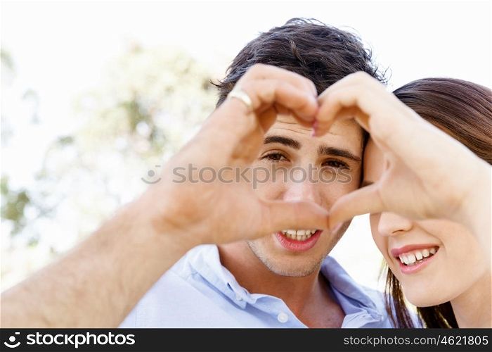 Young couple in the park. Young couple in the park and heart symbol