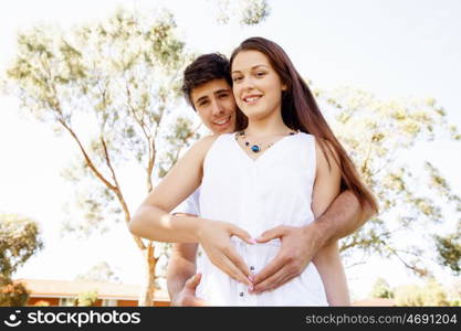 Young couple in the park. Young couple in the park and heart symbol