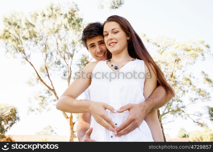 Young couple in the park. Young couple in the park and heart symbol