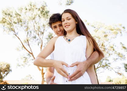 Young couple in the park. Young couple in the park and heart symbol