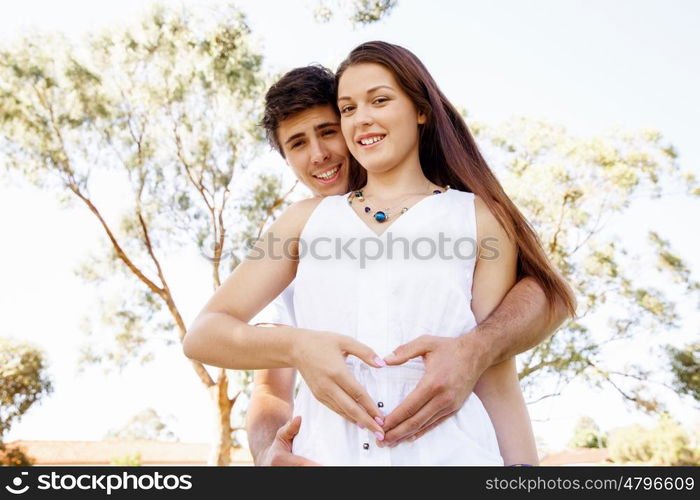 Young couple in the park. Young couple in the park and heart symbol