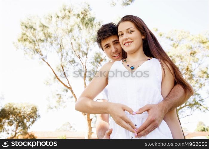 Young couple in the park. Young couple in the park and heart symbol