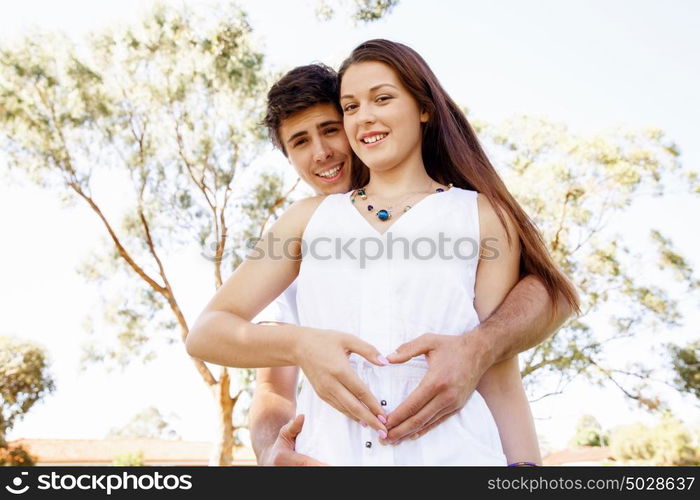 Young couple in the park. Young couple in the park and heart symbol