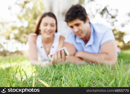 Young couple in the park. Young couple in the park with mobile phone